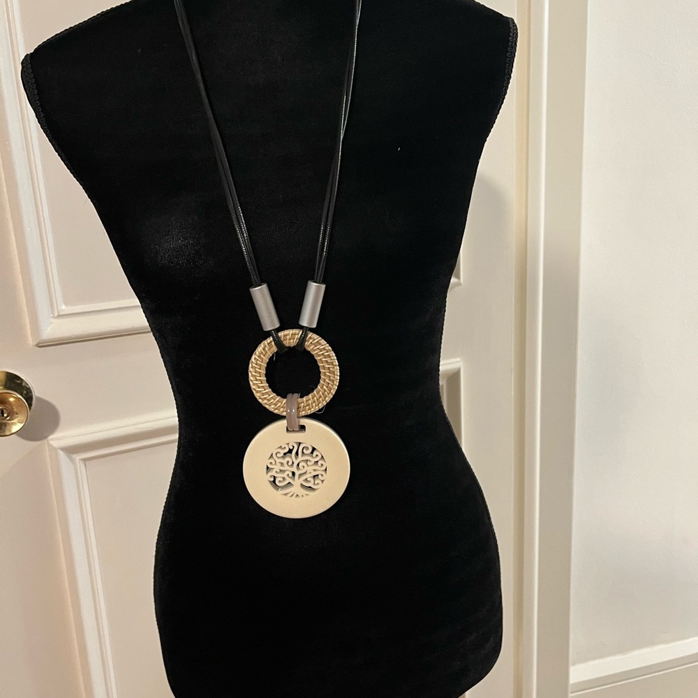 Long necklace with tree design and braided circle